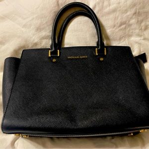 Michael Kors black purse. Comes with dust bag and crossbody strap.